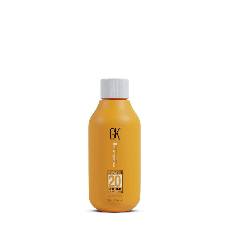 Orange hair product bottle with white cap on a white background