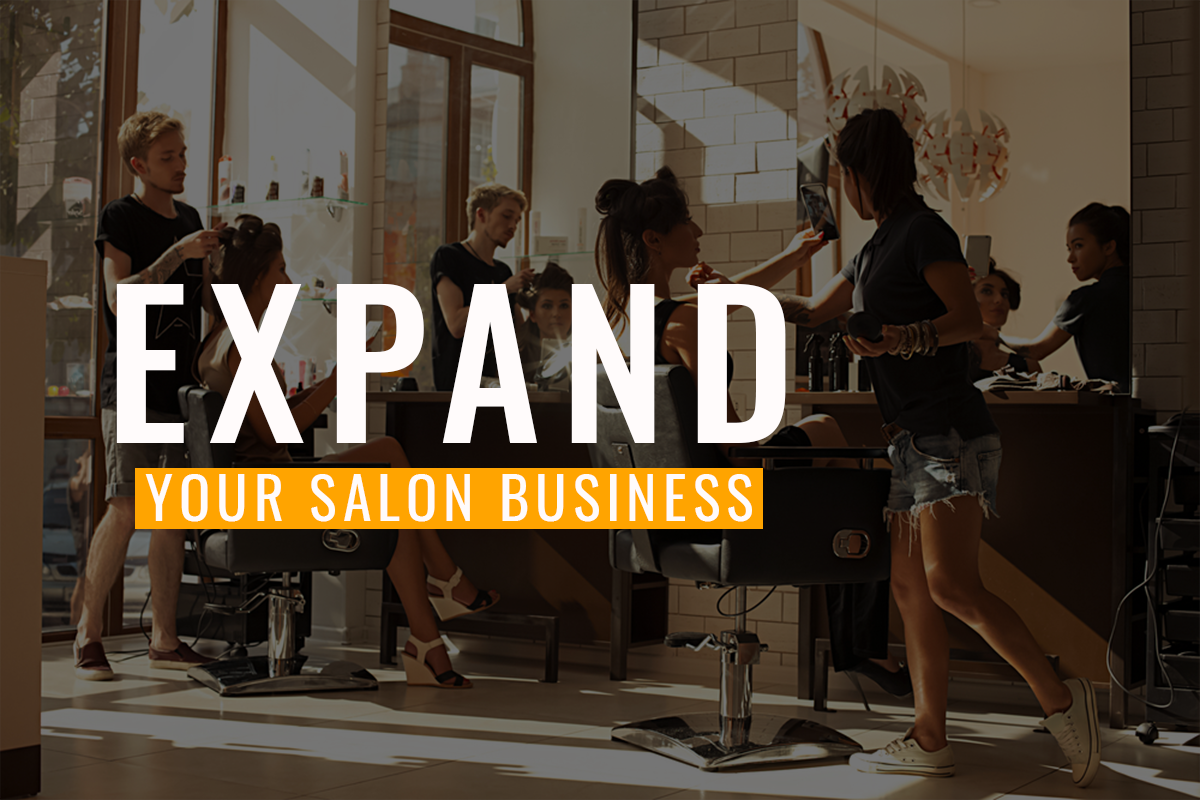Salon owner greeting a client at the front desk of a busy hair salon