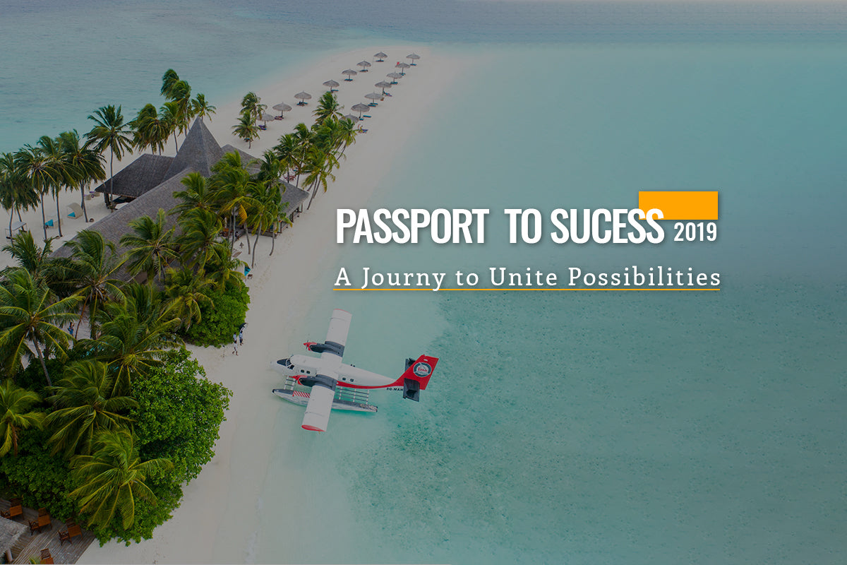 Aerial view of a red and white seaplane on turquoise water beside a palm-lined beach resort