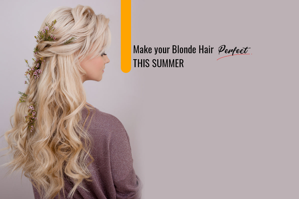 Woman with long platinum blonde hair standing outdoors in bright summer sunlight