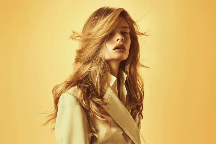 A Bold Woman Blonde Hair Look Against Yellow Background