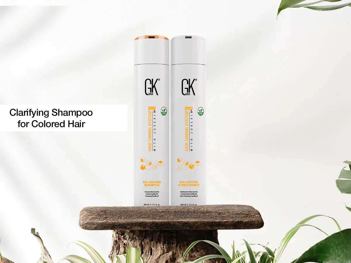 Clarifying balancing shampoo bottle beside smooth color-treated hair in a salon setting
