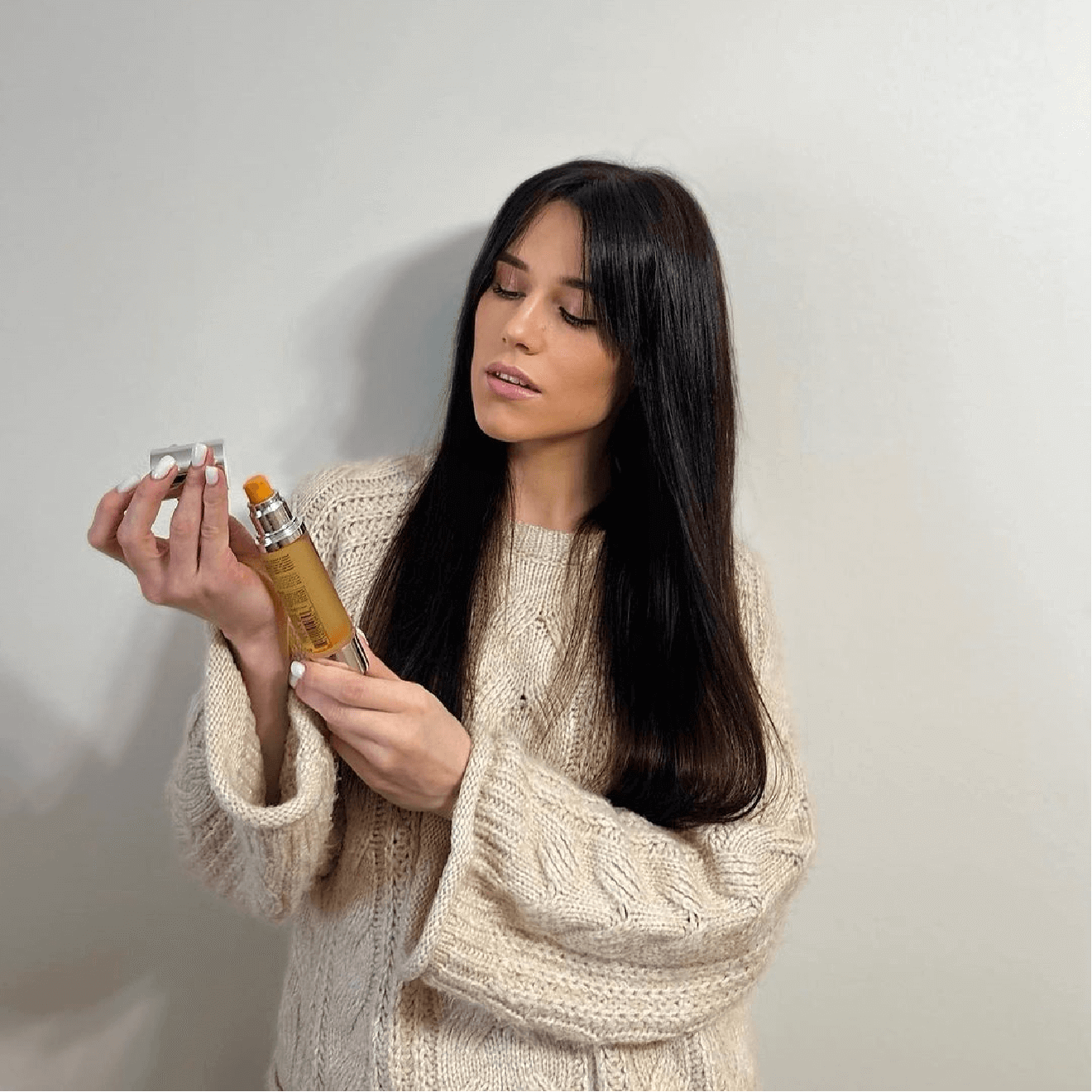 Woman running a wide-tooth comb through long, thick dark hair