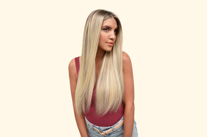 Woman with light blonde hair falling past her shoulders in soft waves