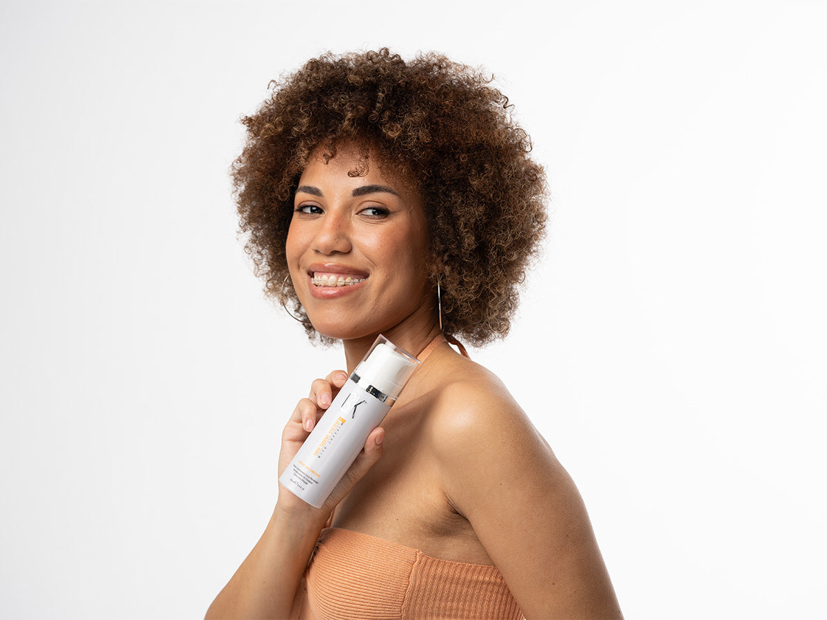 A Lady holding a leave in conditioner