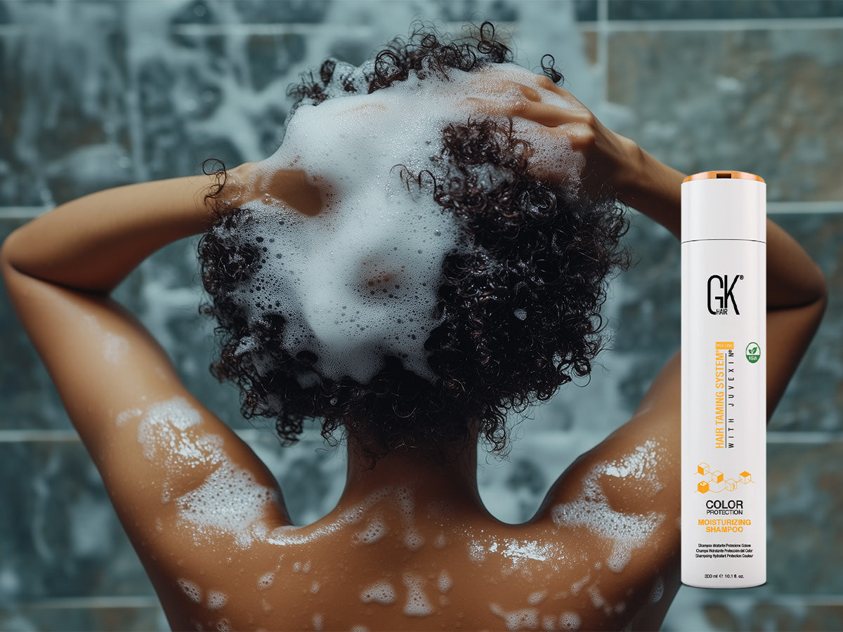 A lady washing her hair with a sulfate free shampoo