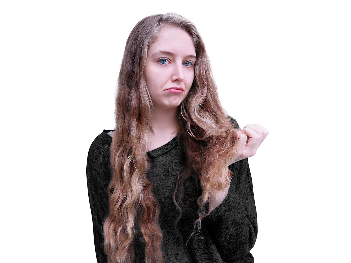 Close-up of frayed split ends at the tips of long brown hair