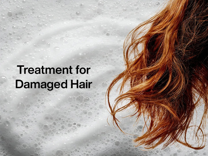 Close-up of wavy, reddish hair against a background of white bubbles, with text overlay: "Treatment for Damaged Hair."