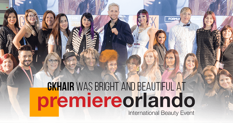 Large group of stylists and models with colorful hair posing at the Premiere Orlando event