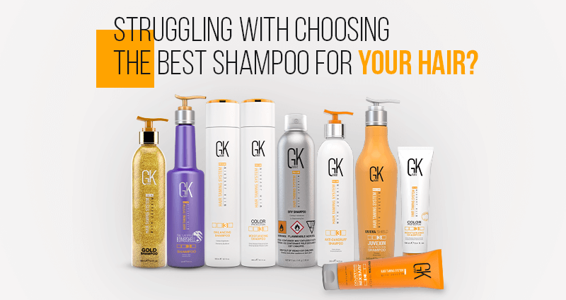 Row of GK Hair shampoo bottles in gold, purple, orange and white against a white background