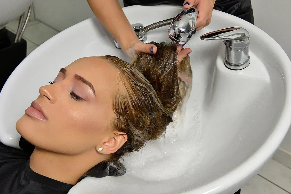 Bottle of GK Hair keratin leave-in conditioner used to protect hair from dryness and breakage