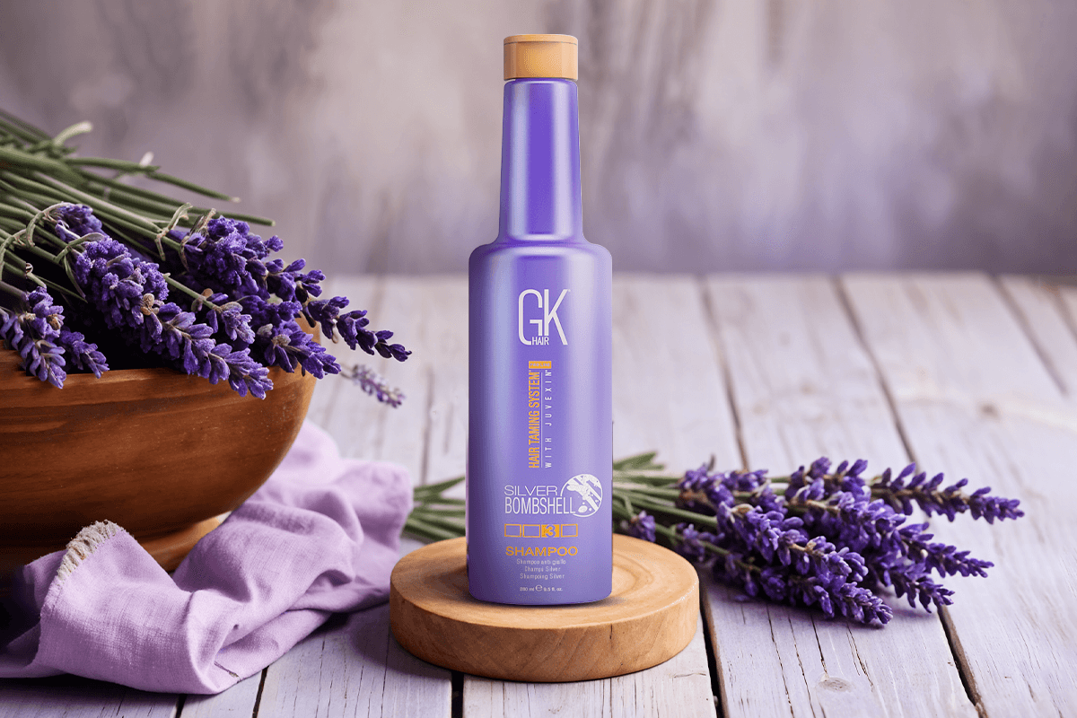 Purple shampoo being applied to wet blonde hair to neutralize brassy yellow tones