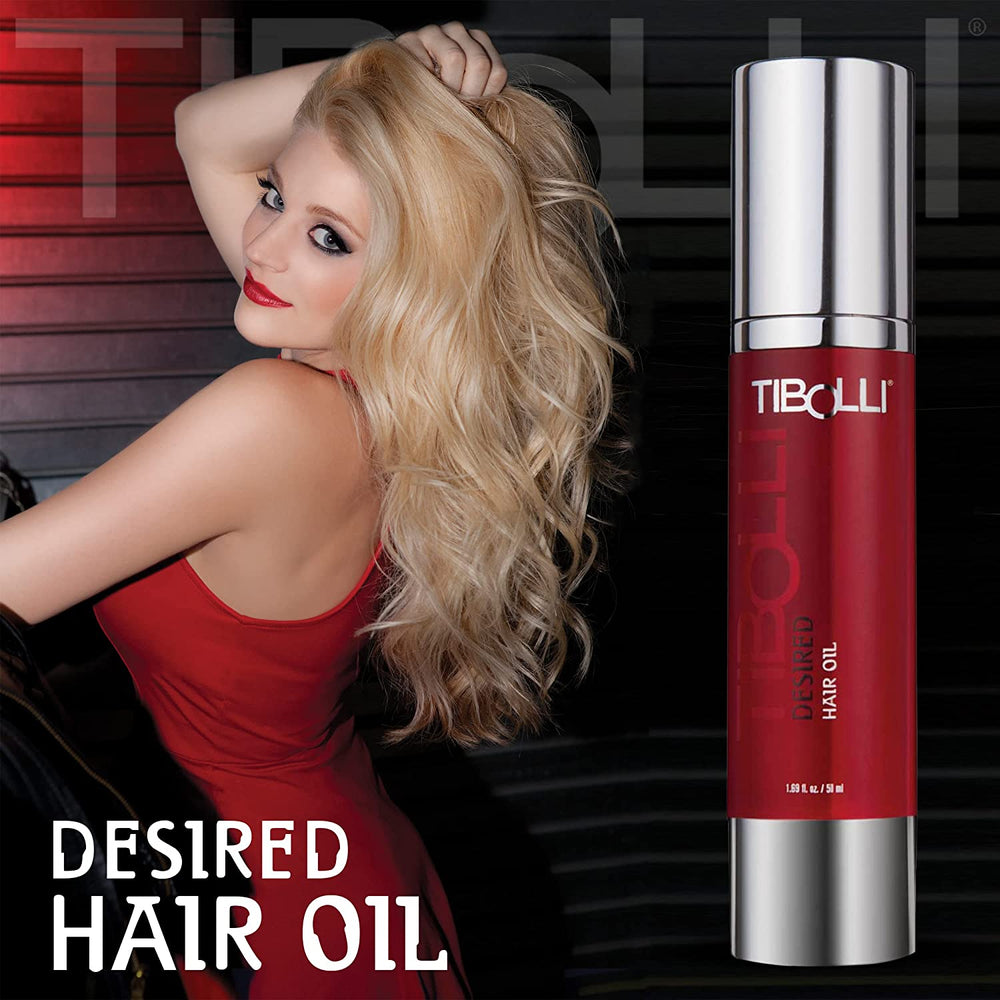 Tibolli Desired Hair Oil in a red 1.69 fl. oz. / 50 ml pump bottle beside a blonde model in a red dress with long wavy hair