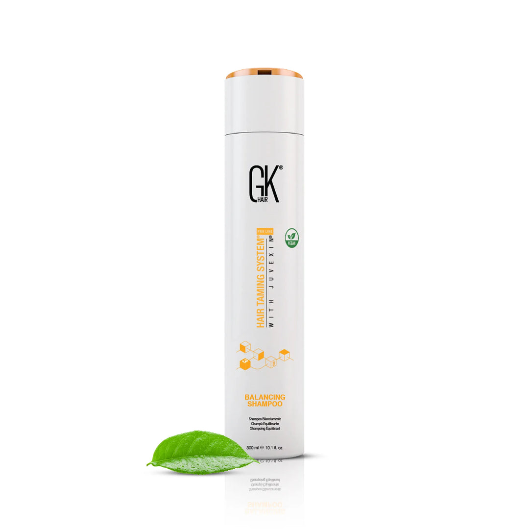 GK Hair Balancing Shampoo 300 ml, with a green leaf in the foreground.