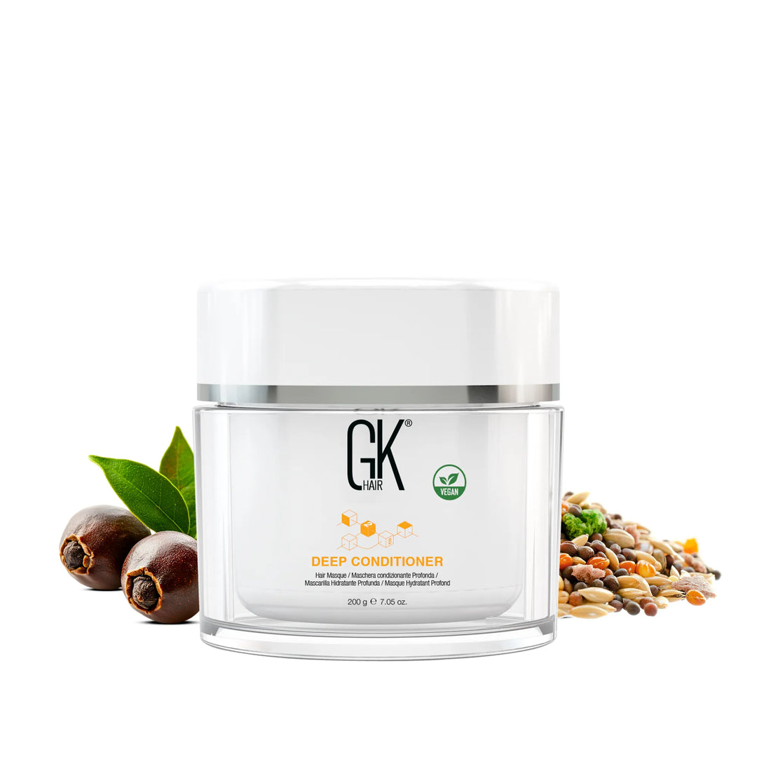 GK Hair Deep Conditioner 200 g / 7.05 oz clear jar with a white lid, vegan badge, jojoba nuts and mixed seeds beside it