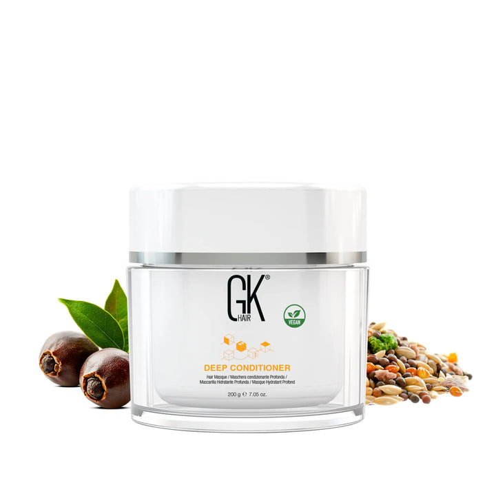 GK Hair Deep Conditioner 200 g / 7.05 oz clear jar with a white lid, vegan badge, jojoba nuts and mixed seeds beside it
