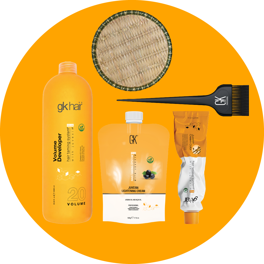 GK Hair coloring kit on an orange circle: 20 Volume Developer, Juvexin Lightening Cream, Juvexin Cream Color tube and a tint brush
