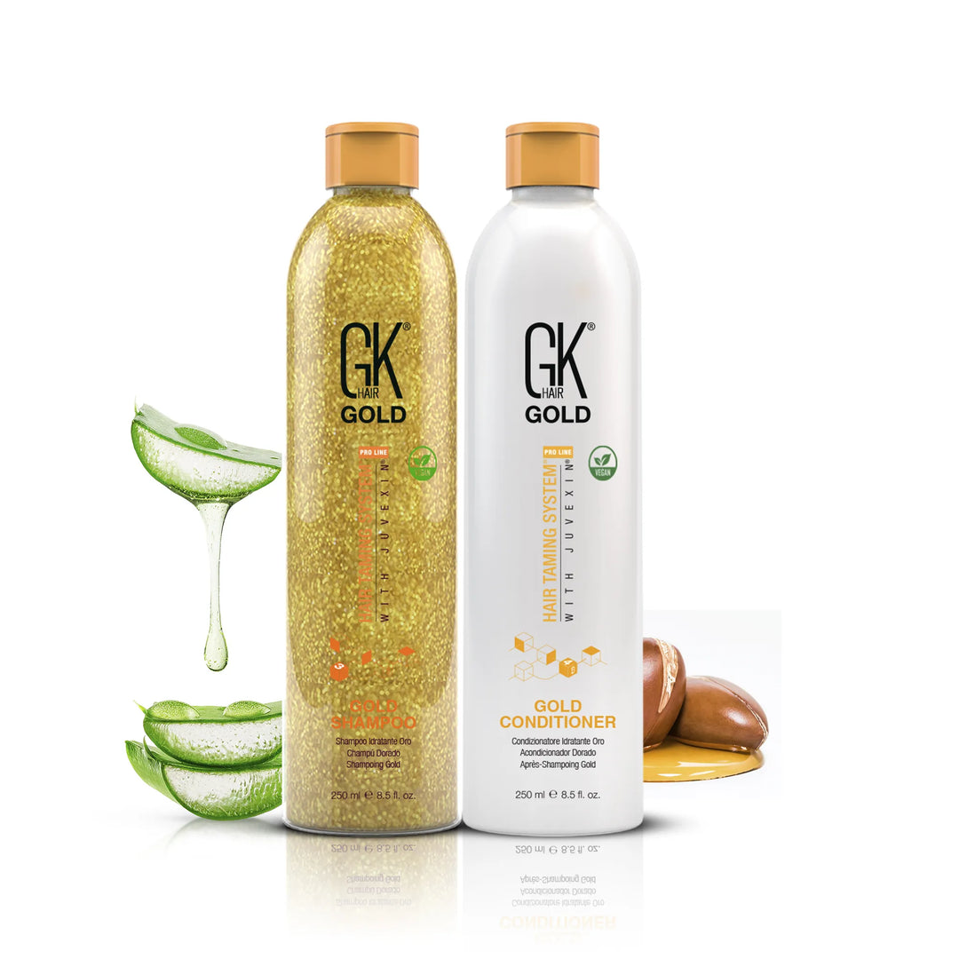 GK Hair Gold Shampoo and Gold Conditioner 250 ml bottles side by side with aloe vera and argan nuts on white