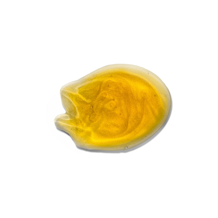 A glistening, translucent Gold Shampoo blob on a white background, showcasing a smooth, rounded shape.