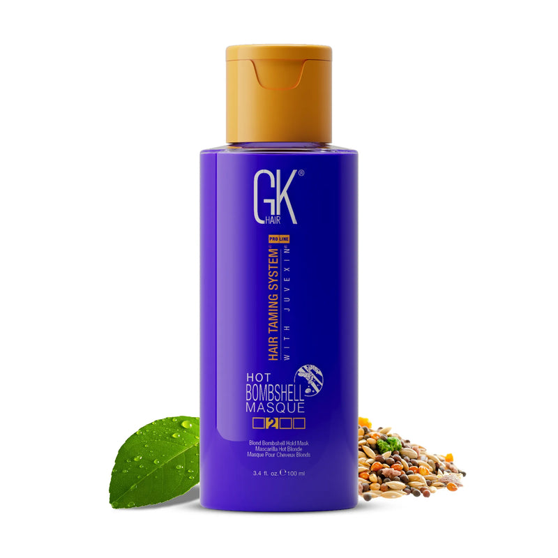 GK Hair Hot Bombshell Masque 3.4 fl. oz. / 100 ml violet bottle with a gold cap, a dewy leaf and mixed seeds beside it