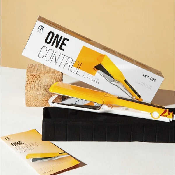 GK Hair ONE CONTROL Titanium Flat Iron in yellow leaning on its white box, which prints 120°C - 232°C, on a beige backdrop