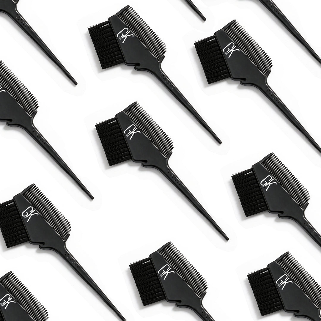 Rows of black GK Hair brush-and-comb applicators laid diagonally on white