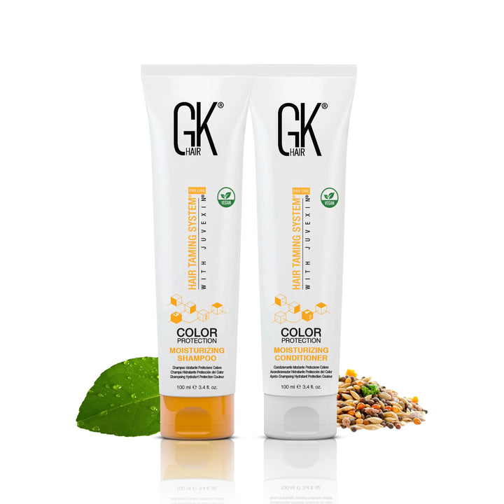 GK Hair Color Protection Moisturizing Shampoo and Conditioner 100 ml tubes side by side with a green leaf and seeds