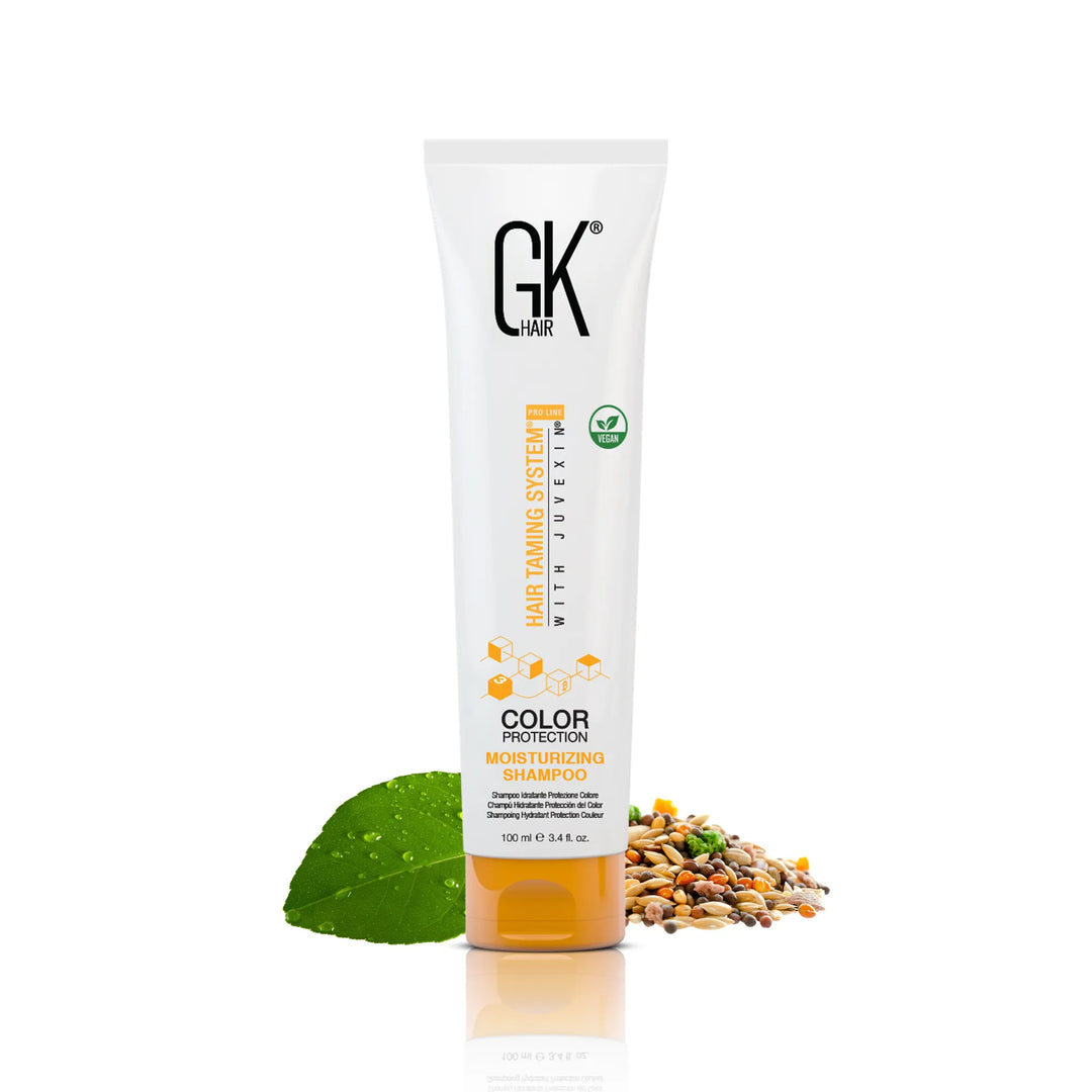 GK Hair Color Protection Moisturizing Shampoo 100 ml white tube with an orange base, green leaf and seeds beside it
