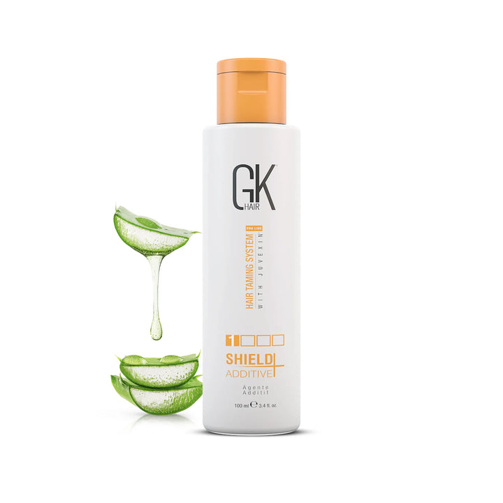 GK Hair Shield Additive 100 ml/3.4 fl. oz. white bottle with an orange cap beside sliced aloe vera dripping gel, on white