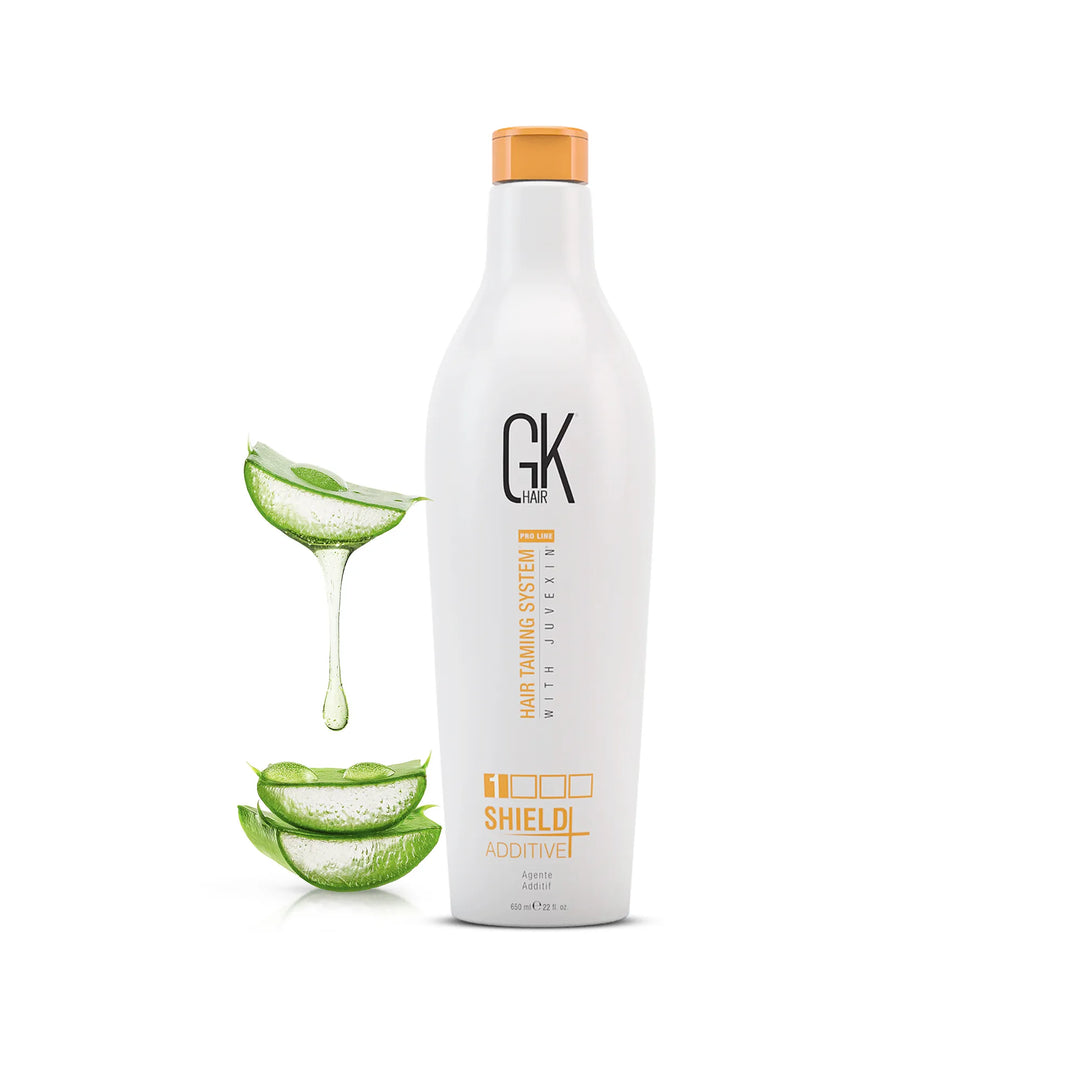 GK Hair Shield Additive 650 ml white bottle with an orange cap, aloe vera slices and dripping gel beside it