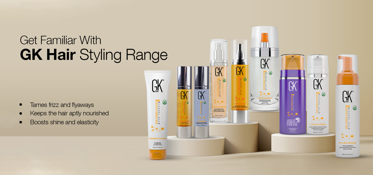 GK Hair Styling Range banner, nine styling bottles on beige podiums; tames frizz and flyaways, nourishes hair, boosts shine and elasticity