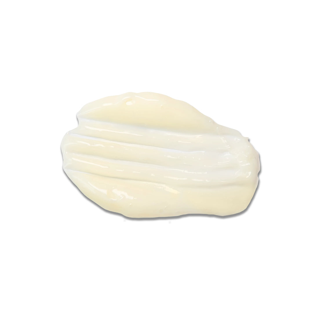 Thick glossy off-white hair cream swirled into a smooth swatch on a white background, texture close-up