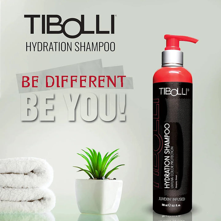 Tibolli Hydration Shampoo 300 ml black bottle with a red pump by folded towels and a potted plant; text: Be Different Be You!