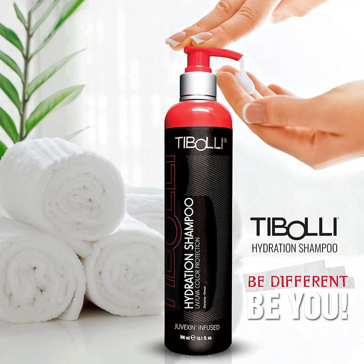 Hands pumping Tibolli Hydration Shampoo 300 ml black bottle with red pump by rolled towels; text reads Be Different Be You!
