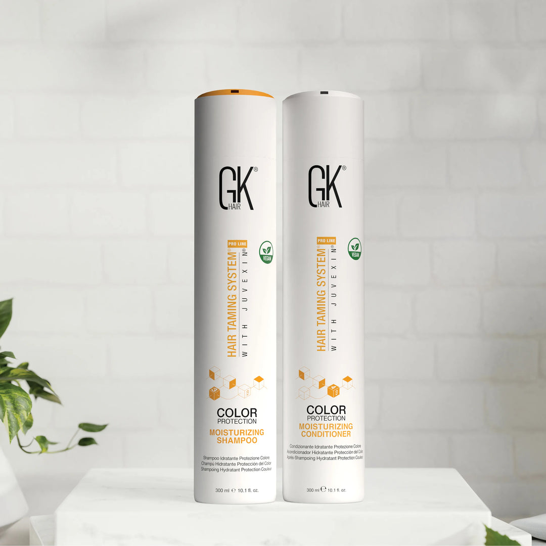 GK Hair Color Protection Moisturizing Shampoo and Conditioner, 300 ml bottles with green vegan badges, on a white ledge
