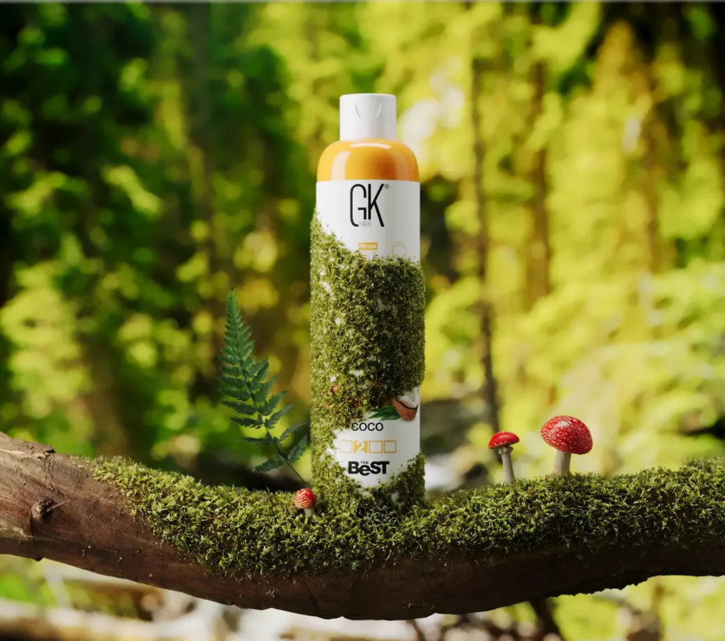 Bottle of GK hair product on a branch with greenery