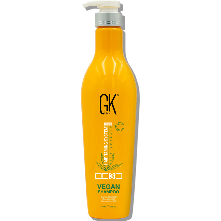 A GK Hair Vegan Shampoo 650ml featuring a pump dispenser and branding, labeled as part of the Hair Taming System.