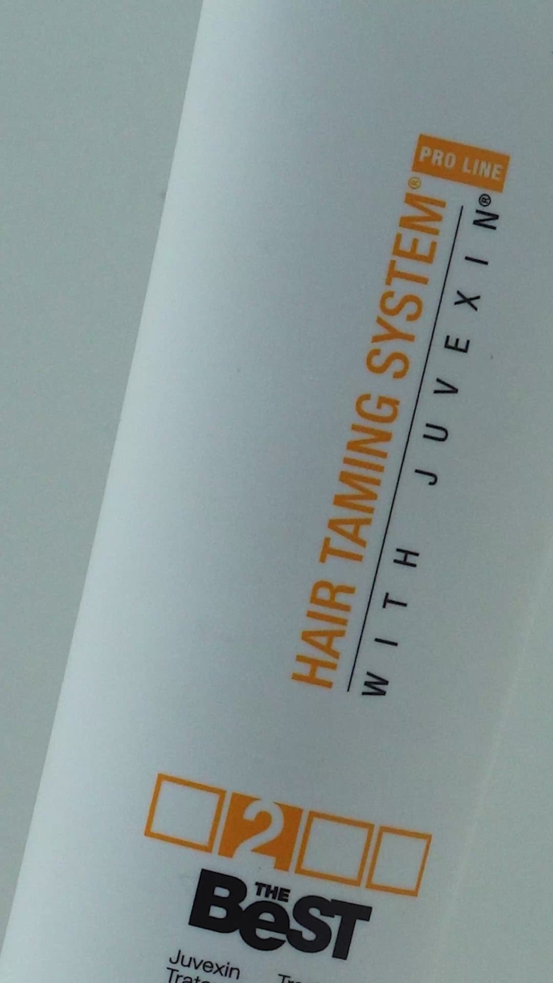 GK Hair The Best Juvexin Treatment 100 ml / 3.4 fl. oz. white tube with an orange flip cap, upright on a white set