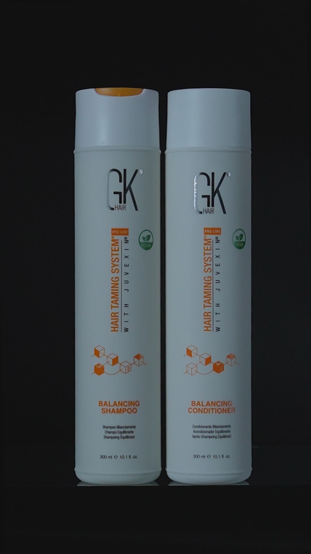 GK Hair Balancing Shampoo and Balancing Conditioner 300 ml bottles side by side on black, then running with white lather