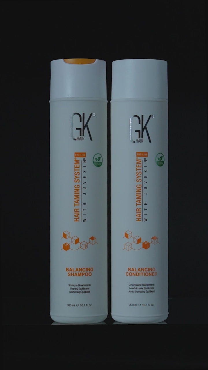 GK Hair Balancing Shampoo and Balancing Conditioner 300 ml bottles side by side on black, then running with white lather