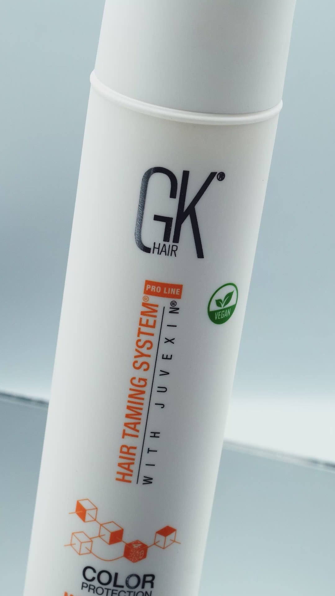 White GK Hair Color Protection Hair Taming System with Juvexin bottle, vegan badge, wreathed in foam and thick cream